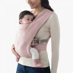 Mom wearing baby inward facing in Blush Pink Embrace Baby Carrier